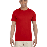 Man wearing a Gildan SoftStyle T-shirt in "Red" color, standing with a relaxed posture and smiling.