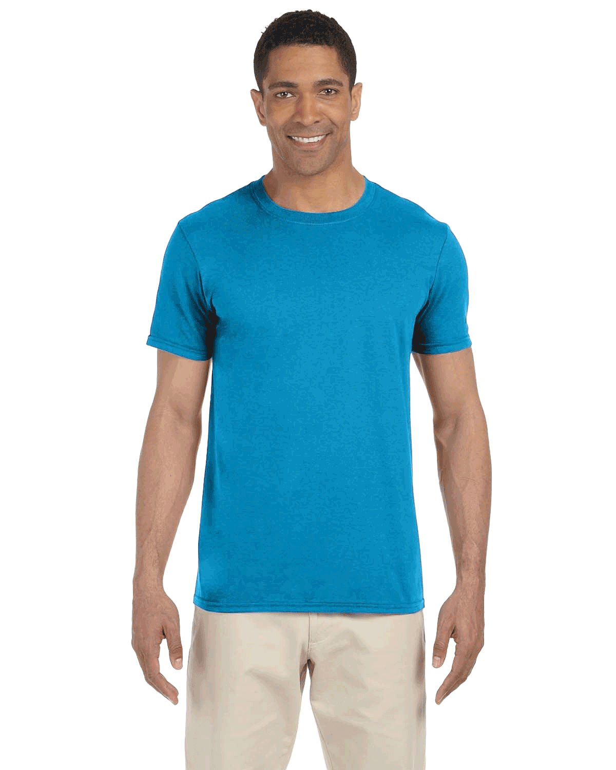 Man in a "Sapphire" colored Gildan SoftStyle T-shirt, standing with a relaxed posture and a friendly smile.