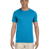 Man in a "Sapphire" colored Gildan SoftStyle T-shirt, standing with a relaxed posture and a friendly smile.