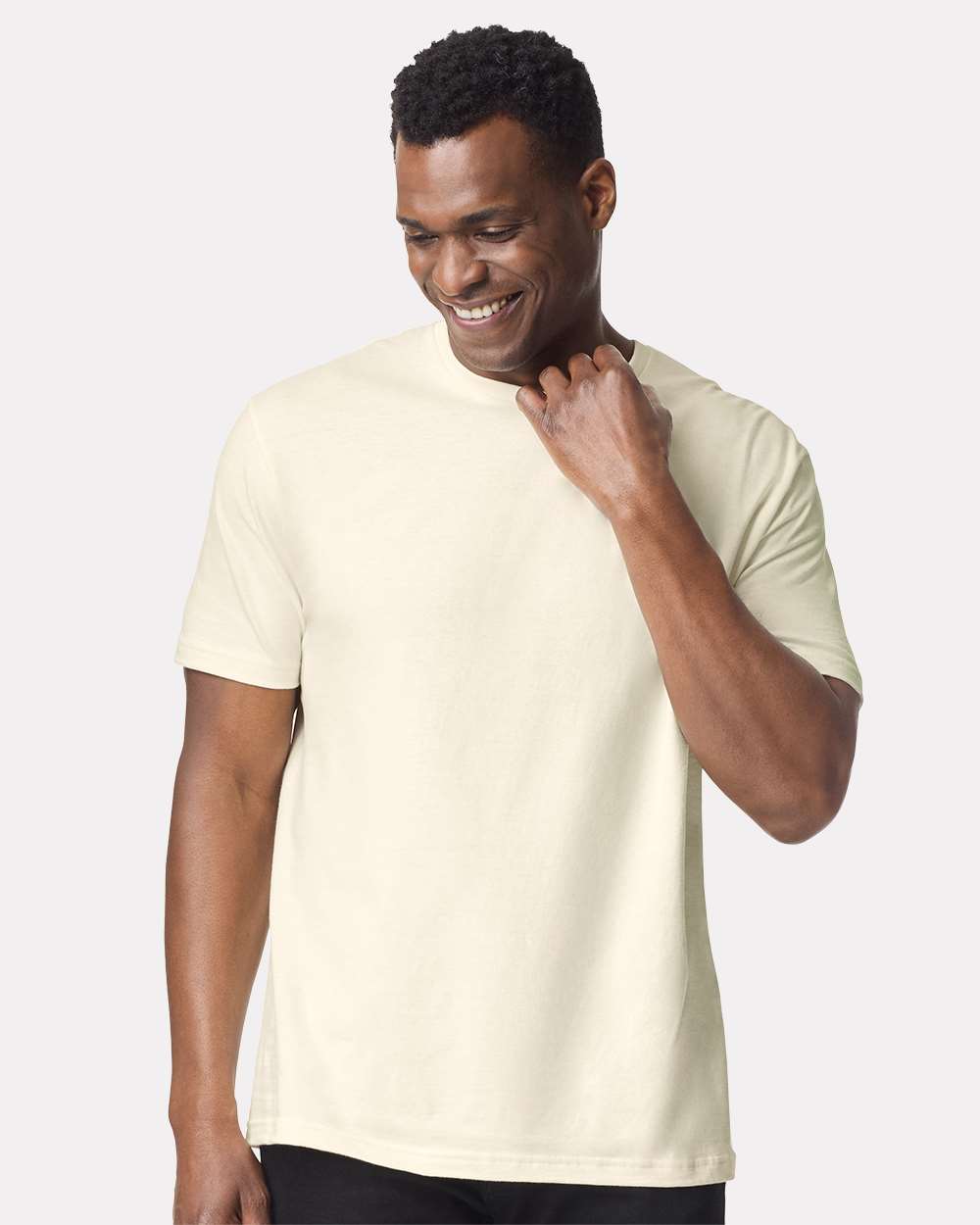 Man wearing a beige t-shirt against a white background