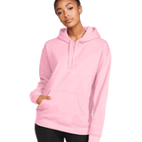 Front view of a woman wearing a Gildan Adult Softstyle Fleece Pullover Hoodie in the Light Pink color, standing with a neutral expression