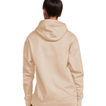 Back view of a woman wearing a Gildan Adult Softstyle Fleece Pullover Hoodie in Sand color.