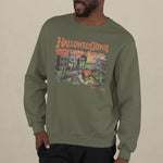 A male model wearing a vintage green sweatshirt with a retro graphic print of a spooky town with a large pumpkin in front of a building. The text on the sweatshirt reads Halloweentown Est. 1998