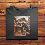 A Black folded Comfort Colors Tshirt, laying on a wooden table. The vintage design has Jason Vorhees from Friday the 13th, and Michael Meyers from Halloween, both in cozy flannels sitting together in a pumpkin patch. Jason is showing off his jack o lantern