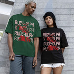 Two models wearing a vintage moss and black comfort colors shirts. The design features Rudolph the Red Nosed Reindeer in a y2k merch artstyle, posed in a rude manner. There is text that says Rude-olph, a funny pun with his name to go with the graphic