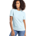 Woman in an "Ice Blue" Next Level Apparel Unisex CVC Crewneck T-Shirt, standing with a relaxed posture and a slight side glance.