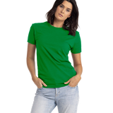 Woman wearing a Next Level Apparel Unisex CVC Crewneck T-Shirt in "Kelly Green" color, standing with hands in pockets and a slight head tilt.