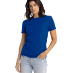 Woman wearing a Next Level Apparel Unisex CVC Crewneck T-Shirt in "Royal" color, standing with a neutral expression and one hand in her pocket.