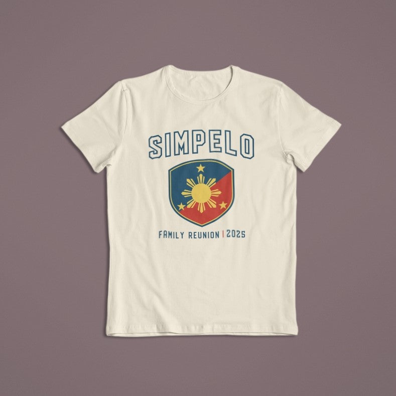 Cream-colored Simpelo Family Reunion 2025 t-shirt with a bold blue and red shield graphic featuring a yellow sun and stars, ideal for reunion keepsake apparel.