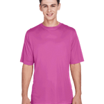 Boy wearing a Team 365 Men's Zone Performance T-Shirt in "Sport Charity Pink" color, standing with a relaxed posture and smiling.