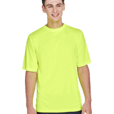 Boy in a "Safety Yellow" Team 365 Men's Zone Performance T-Shirt, standing with a relaxed posture and a cheerful expression.