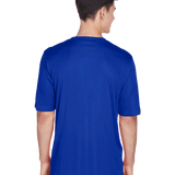 Back view of a boy wearing a Team 365 Men's Zone Performance T-Shirt in "Sport Royal" color, standing with a relaxed posture.