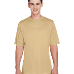 Boy in a "Sport Vegas Gold" Team 365 Men's Zone Performance T-Shirt, standing with a relaxed posture and a cheerful expression.