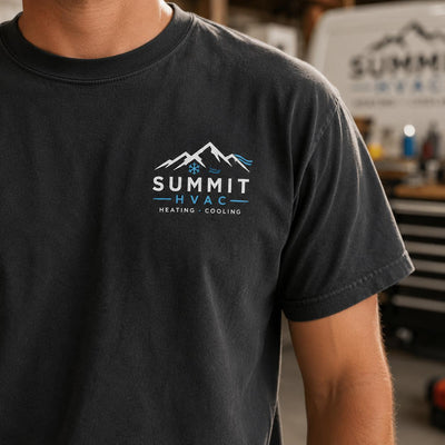 Close-up of a Summit HVAC left chest logo printed on a dark gray crew shirt