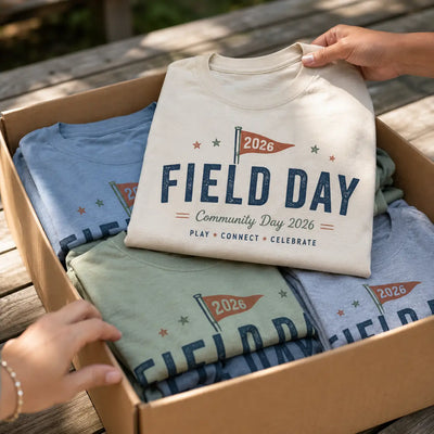 Box of folded custom Field Day 2026 shirts for a community event order