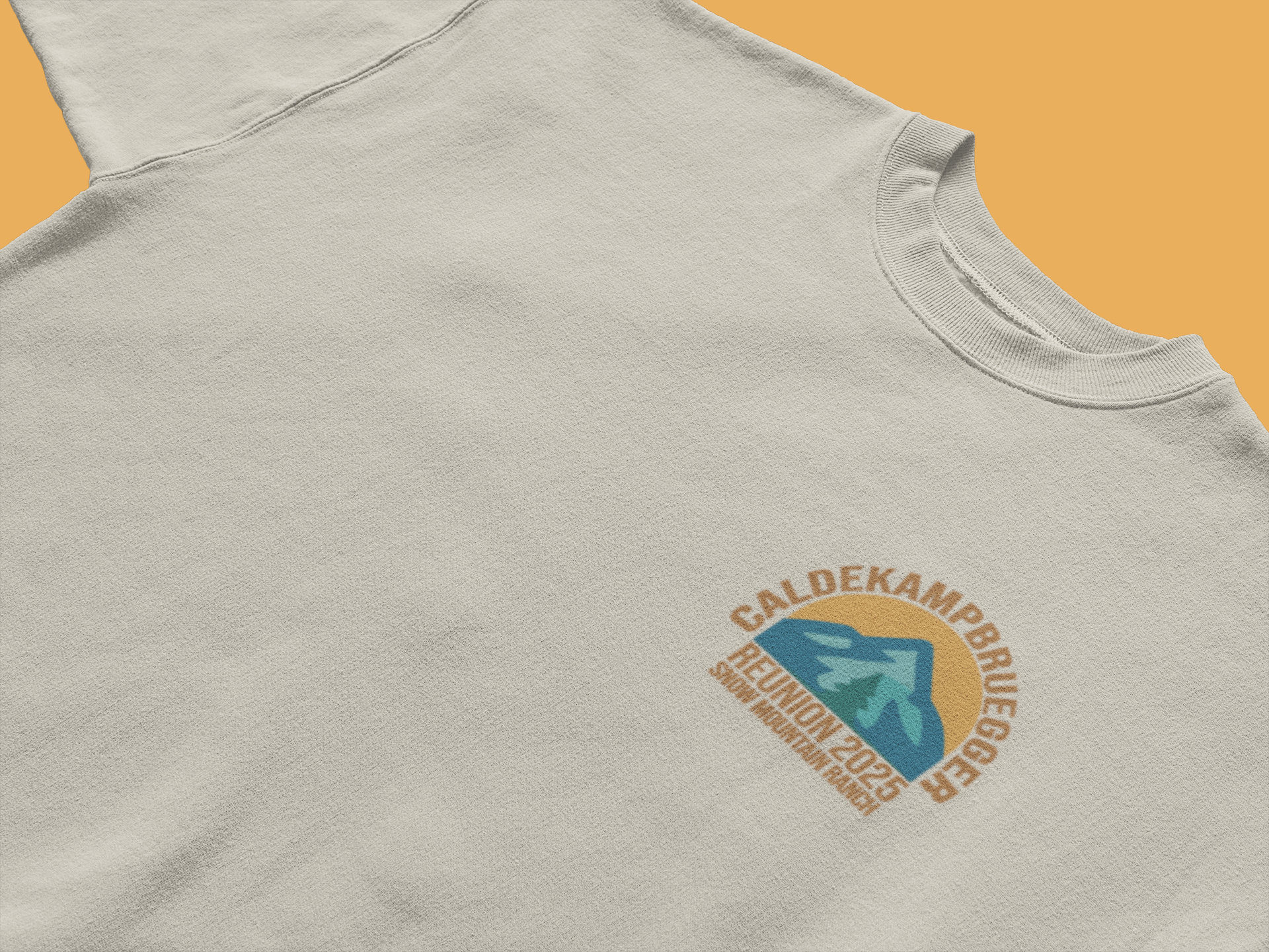 Oatmeal CALDEKAMP BRUEGER family reunion 2025 T-shirt featuring small arch mountain-arrow logo on left chest